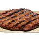 A Burger King patty sits on a piece of paper.